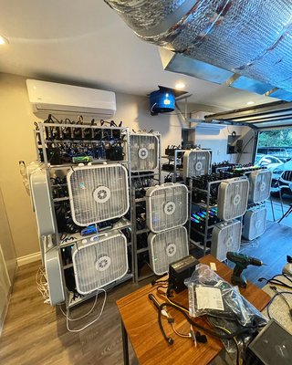 AmA mining farm - We were thrilled to build our client a mining garage with over 15 mining machines, this farm can do some serious numbers. To have a farm this big stability is priority, here at AmA we put the rigs under extreme software stress and troubleshoot to make sure once it leaves our facility it runs smooth. It was not easy achieving such mass mining farm but over 8 weeks we were able to get the entire garage up and running. Box fans are moving the hot air out of the machines and a 5 ton AC is blowing to keep the Graphic cards cool.