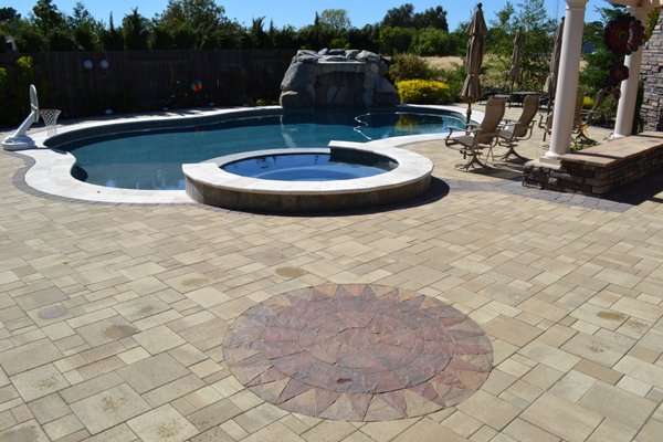 Pool Deck Transformation - This backyard remodel was done on outdated, run down stained concrete. With already beautiful fixtures such as the pool and landscaping this dull concrete put a damper on such a lovely backyard. With a wonderful upgrade to Paver Stones this backyard and pool deck truly came to life, transforming this customers backyard into an oasis of the their own!