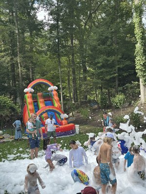 Rainbow Foam Party - A high-energy backyard celebration featuring a colorful inflatable slide and a foam party for nonstop summer fun. Rainbow Foam Party - A high-energy backyard celebration featuring a colorful inflatable slide and a foam party for nonstop summer fun.