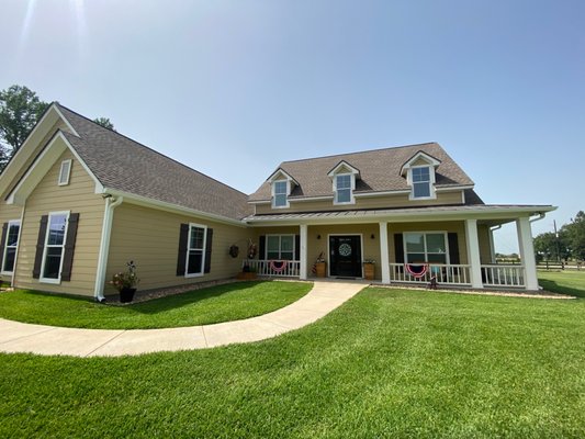 6" Seamless Gutters - Charming Waller Home - We installed 6" k-style seamless aluminum gutters with 3x4" rectangular downspouts in white on this lovely custom home.