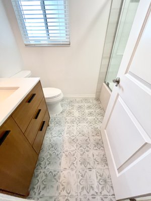 Torres Guest Bathroom - Who says your guest bathroom can't have some style too?  Even small bathrooms can feel spacious with the right materials and colors. We loved transforming this space for our client by using a fun floor tile and large format shower wall tiles.
