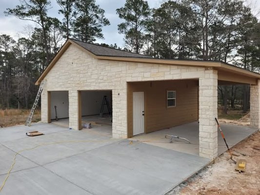 2 car garage build - this is a two car garage, with Hardy siding and natural stone front. we built the entire building from frame to finish. the only thing we didn't have a hand in was pouring the foundation or pouring the driveway. but we did everything else from framing, to roughing in, installing the stone facing, installing the Hardy siding, installing the felt and asphalt shingles, lighting, the garage doors and stairway and attic door, shelving in the back of building for tools and other automotive accessories 2 car garage build - this is a two car garage, with Hardy siding and natural stone front. we built the entire building from frame to finish. the only thing we didn't have a hand in was pouring the foundation or pouring the driveway. but we did everything else from framing, to roughing in, installing the stone facing, installing the Hardy siding, installing the felt and asphalt shingles, lighting, the garage doors and stairway and attic door, shelving in the back of building for tools and other automotive accessories