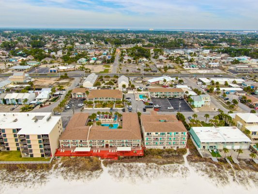 Main Building - Our Main Building is located directly on the beach. It consists of pool side rooms, gulf front rooms and gulf front two-room suite options. The largest of our two pools is located at the main building as is our large sun deck where our main beach access is found. You will find charcoal grills as well as picnic tables on our large sun deck to use on a first come first served basis. Main Building - Our Main Building is located directly on the beach. It consists of pool side rooms, gulf front rooms and gulf front two-room suite options. The largest of our two pools is located at the main building as is our large sun deck where our main beach access is found. You will find charcoal grills as well as picnic tables on our large sun deck to use on a first come first served basis.