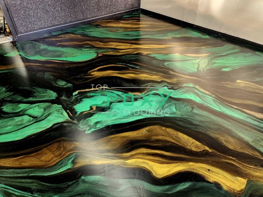 Custom Green, gold and black base metallic epoxy floor. metallic epoxy floor in a basement - Green, gold, and black base metallic epoxy floor, this is one of our favorite metallic floors we ever designed. Custom Green, gold and black base metallic epoxy floor. metallic epoxy floor in a basement - Green, gold, and black base metallic epoxy floor, this is one of our favorite metallic floors we ever designed.