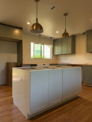 Open Concept Kitchen Renovation In San Rafael - Here’s what our team is executing:

Open-Concept Living: The wall is down, seamlessly connecting the kitchen and living room into one grand, light-filled space.

Butcher Block Center: We're building a gorgeous new center island that will feature a custom, warm butcher block countertop.

Relocated Workflow: The flow of the kitchen is completely reimagined, with the fridge now positioned near the slider and the oven moved to a more functional location.

Seamless Flooring: Goodbye laminate! Beautiful new red oak flooring is going in, expertly matched to the existing living room for a unified look.

Ambiance Upgrade: To top it all off, we’re installing brand-new 6-inch LED recessed lighting throughout the entire space, and stylish pendants are on the way to hang over the new island.

At KCK Construction & Remodeling, we do kitchens re-designs as well. Whether you are looking to remove walls, reconfigure your space, or simply match your existing hardwood, our t