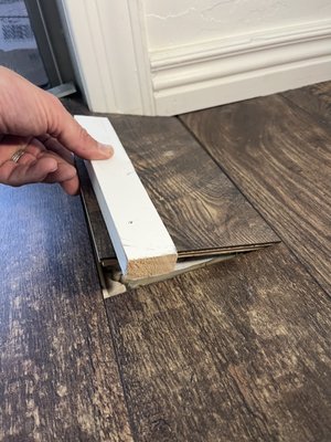 Click and lock Flooring Repair - This was replacement of damaged click and lock flooring that was previously cut around an object. Carefully removed damaged pieces and replaced with extra pieces provided by the homeowner. Click and lock Flooring Repair - This was replacement of damaged click and lock flooring that was previously cut around an object. Carefully removed damaged pieces and replaced with extra pieces provided by the homeowner.