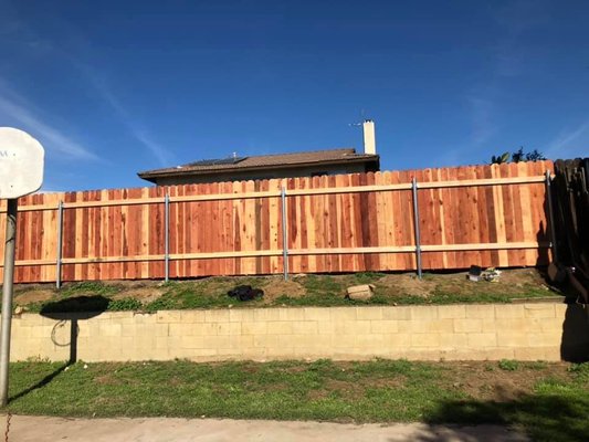 Redwood Fencing w/ DogEar Pickets - This is our common wood fencing that is most requested. It consists of an option for round steel posts or square wood posts and 6" or 8" wide wood pickets that are 8ft sections. Redwood Fencing w/ DogEar Pickets - This is our common wood fencing that is most requested. It consists of an option for round steel posts or square wood posts and 6" or 8" wide wood pickets that are 8ft sections.
