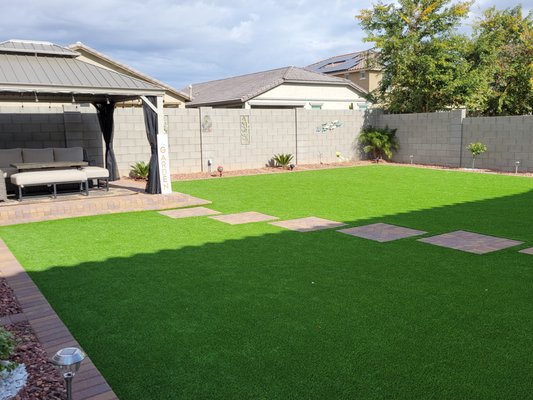 Backyard new build - This was a new build. The yard was dirt and had to be leveled. Installed pet turf and native pavers and border as well a decorative rock. Our team of expert deign consultants can help you design your yard from scratch or change existing.