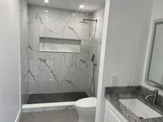 Adam's Guest Bathroom - Adam needed his guest bathroom remodeled as it was outdated, and the cabinets were falling apart. Take a look at these pictures to see how much we changed this bathroom and brought it to life. We did the floors, tile, paint, shower fixtures, toilet, vanity cabinet and new quartz countertop. Give us a call and get a quote now!!