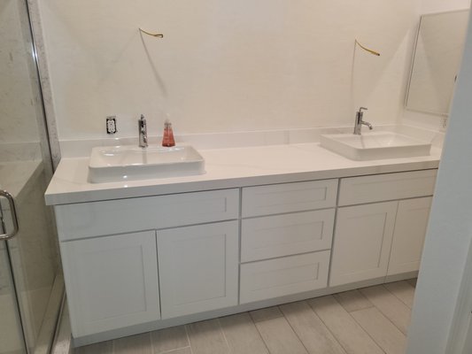 Small multi room remodel - A 2 area remodel including a bathroom and a family room entertainment wall. We installed new cabinets in each at a moments notice and waited for owner to install counter tops. We then came back and patch drywall. After owner painted, we came back again and hung illuminated mirrors in the bathroom and shiplap siding in the family room. We are putting the finishing touches on it now which will include trimming out the electrical and hanging a flat screen TV.