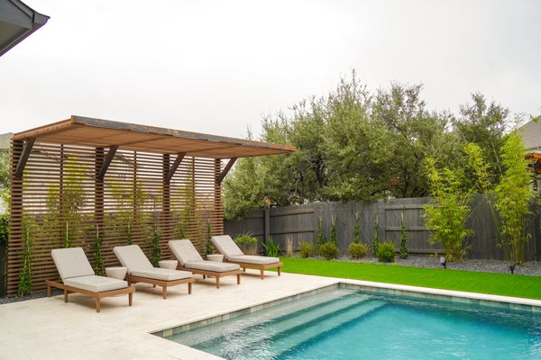 Lake Pointe - We are thrilled with this Lake Pointe oasis! Our design + install team saw this project through from start to finish, creating an incredible yard for entertaining! Our clients love curling up as a family for movie nights under the shade structure or lounging under the cantilevered pergola on a hot day. The turf game court is the best spot for corn hole and non-invasive bamboo provides additional privacy. Lueder pavers and gravel planting beds finish the yard off by integrating walkways and seasonal interest throughout the space. We can’t wait to transform your yard next!