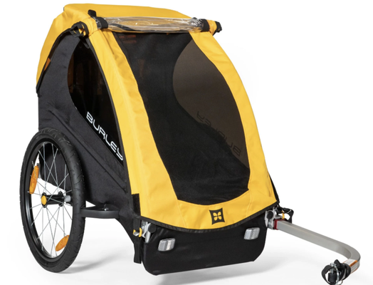 Bee Trailer Single - The Burley Bee - bike trailer, is a long-standing favorite for biking with children. With UV-protected windows, front and rear reflectors, and a 5-point harness, the Bee takes both safety and comfort seriously. And with its simple hitching system, the Bee makes it easy to enjoy family bike rides any day of the week. Bee Trailer Single - The Burley Bee - bike trailer, is a long-standing favorite for biking with children. With UV-protected windows, front and rear reflectors, and a 5-point harness, the Bee takes both safety and comfort seriously. And with its simple hitching system, the Bee makes it easy to enjoy family bike rides any day of the week.