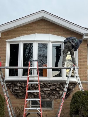 Window Replacement - Our skilled installers can help support a bow window replacement.  Bow windows are curved window structures that project outward from a home, typically consisting of three or more window panels joined together to create a gentle, arched shape. They provide a panoramic view, add architectural interest, and increase natural light in the interior space.