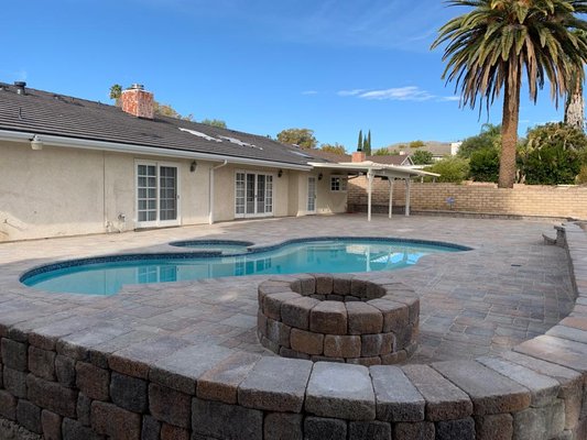 Full Backyard Remodel - Beautiful backyard renovation. We transformed an empty space into an enjoyable area for all, a project that included pool remodel, pavers, fireplace, patio cover and more!