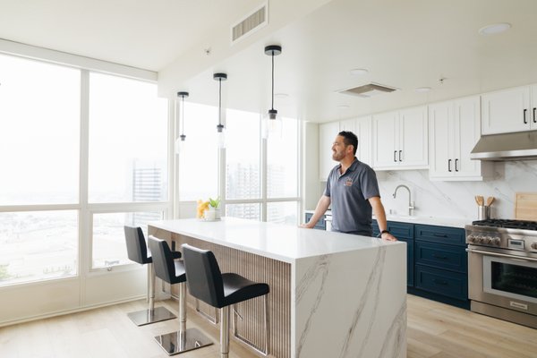 Modern Downtown Condo Kitchen Transformation - This Downtown San Diego high-rise kitchen was completely transformed from an outdated layout into a modern, functional centerpiece. We performed a full gut renovation, installing custom cabinetry, premium quartz countertops with a waterfall island, and updated appliances to create a cohesive and elevated design. Our team carefully coordinated logistics within the condo building to ensure a smooth and efficient remodel process.