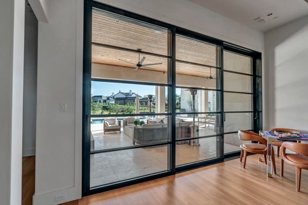 Aluminum Sliding Doors - By using our sleek "lift and slide" aluminum sliding doors for your entryways we can maximize natural light and flow with using them as interior glass partitions or seamless barriers to the outdoors. Whether it's creating an enclosure of a patio or turning an unused formal living room into a modern office our aluminum sliding door systems create versatile solutions. Aluminum Sliding Doors - By using our sleek "lift and slide" aluminum sliding doors for your entryways we can maximize natural light and flow with using them as interior glass partitions or seamless barriers to the outdoors. Whether it's creating an enclosure of a patio or turning an unused formal living room into a modern office our aluminum sliding door systems create versatile solutions.