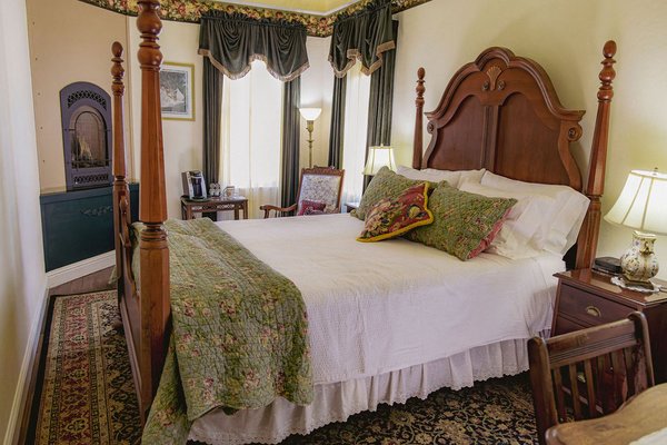 Golden Jubilee - Room 6 - Relax in Golden Jubilee, a luxurious suite in downtown Weaverville that makes the ideal base for all your Trinity County adventures, whether you're visiting friends/family, fishing, or exploring the Trinity Alps. This sun-drenched suite features a queen-sized poster bed, a cozy sitting area next to the fireplace, desk, and in-room champagne tub. Golden Jubilee draws on the period's stunning rich velvety textures and is decked out in calming greens.
All prices are inclusive of cleaning fees.
Golden Jubilee is part of the Weaverville Hotel at the base of the stunning Trinity Alps. Enjoy easy access to hikes, fishing, lakes, mountains and more, making it the perfect base for all your North State adventures.
This suite features:
- A queen-sized poster bed
- An in-room gas fireplace next to a cozy reading nook, complete with your own coffee station and rocking chair
- High speed internet
- A writing desk
- Jetted champagne tub
- Access to a shared parlor space (open from 8 a.m. — 10 p.m.) Golden Jubilee - Room 6 - Relax in Golden Jubilee, a luxurious suite in downtown Weaverville that makes the ideal base for all your Trinity County adventures, whether you're visiting friends/family, fishing, or exploring the Trinity Alps. This sun-drenched suite features a queen-sized poster bed, a cozy sitting area next to the fireplace, desk, and in-room champagne tub. Golden Jubilee draws on the period's stunning rich velvety textures and is decked out in calming greens.
All prices are inclusive of cleaning fees.
Golden Jubilee is part of the Weaverville Hotel at the base of the stunning Trinity Alps. Enjoy easy access to hikes, fishing, lakes, mountains and more, making it the perfect base for all your North State adventures.
This suite features:
- A queen-sized poster bed
- An in-room gas fireplace next to a cozy reading nook, complete with your own coffee station and rocking chair
- High speed internet
- A writing desk
- Jetted champagne tub
- Access to a shared parlor space (open from 8 a.m. — 10 p.m.)