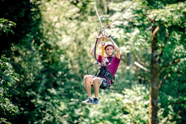 Zipline Tours - Strap in and step up to our departure tower, where the thrill of a lifetime awaits you. Our friendly, well-trained staff fit you into a safety harness, then send you racing through our zip line park. You’ll soar through the sky as you’re treated to a bird’s eye view of Hagg Lake, the surrounding forests and nearby mountains. After crossing the Panama Bridge, feel the rush as you cross our massive 1,280-foot-long zip line. This zip line stretches almost a quarter of a mile, making it one of the longest in the area. You’ll be amazed as the trees whiz past your feet, but you still have plenty of time to take in the sights, sounds and smells of the natural beauty surrounding you. Zipline Tours - Strap in and step up to our departure tower, where the thrill of a lifetime awaits you. Our friendly, well-trained staff fit you into a safety harness, then send you racing through our zip line park. You’ll soar through the sky as you’re treated to a bird’s eye view of Hagg Lake, the surrounding forests and nearby mountains. After crossing the Panama Bridge, feel the rush as you cross our massive 1,280-foot-long zip line. This zip line stretches almost a quarter of a mile, making it one of the longest in the area. You’ll be amazed as the trees whiz past your feet, but you still have plenty of time to take in the sights, sounds and smells of the natural beauty surrounding you.
