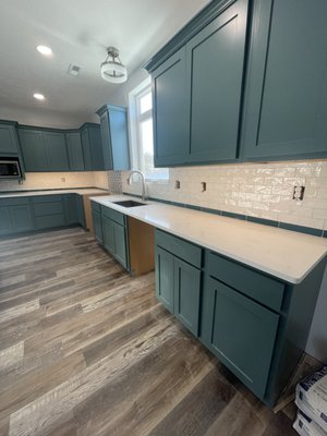 Home remodel - We completed a full kitchen remodel featuring custom cabinetry, sleek new countertops, a stylish tile backsplash, and under-cabinet lighting for added warmth and function. Luxury vinyl plank flooring was installed throughout the home for a cohesive, modern look. In the living room, we elevated the space with a stunning floor-to-ceiling stone fireplace, bringing texture, elegance, and a bold focal point to the heart of the home. Home remodel - We completed a full kitchen remodel featuring custom cabinetry, sleek new countertops, a stylish tile backsplash, and under-cabinet lighting for added warmth and function. Luxury vinyl plank flooring was installed throughout the home for a cohesive, modern look. In the living room, we elevated the space with a stunning floor-to-ceiling stone fireplace, bringing texture, elegance, and a bold focal point to the heart of the home.