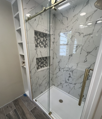 Bathroom Remodel - This was a remodel of a master bathroom that originally had a 36” stand up shower with barely any room to turn around.  We gutted the bathroom and custom built a 48” shower giving plenty of room to move with a clean tile finish.  Having plenty of storage in a shower is always an issue.  Here we created a double (his & hers) shower niche for all those random shower items.