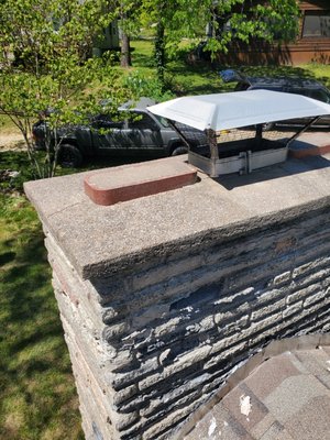 Chimney Demolition and Rebuild, Facia Bricks and Bench - We were called out to repair a leaky chimney constructed out of blacks made on site out of concrete and molds back in the 60's, which are now deteriorating and were covered with a thick waterproofing sealant. 
We demolished the chimney walls and rebuilt using a new Symphony 80 King Acme brick. The customer liked the new look and hired us to demolish and rebuild the block wall on the front of the home and around the concrete foundation of the chimney with the new bricks. 
We removed the flowerbed around the base of the chimney as it was holding water and wicking up moisture into the chimney. We also ripped out and replaced the flashing around the chimney, through the roof sides, as the roofers forgot the counter flashing and the step flashing was insufficient and incorrectly installed.