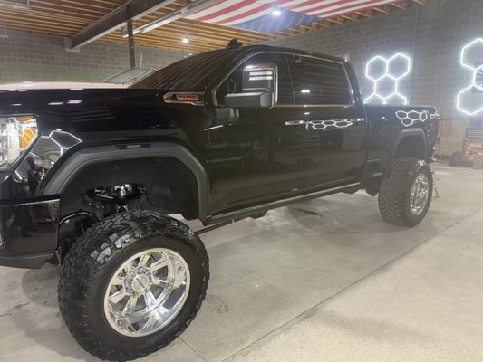 2021 GMC Denali 3500HD - This truck came in with white paint overspray all over the vehicle. The client wanted a show quality finish with the best ceramic coating on the market. We started with a 5000 grit wet sand to remover all the overspray, remove scratches and swirls, and remove orange peel from the factory, then we rotary cut the truck to remove any scratches made from wet sanding, followed by a 2 stage polish to remove any swirls made by the rotary cut and to bring out the true mirror finish in the black paint, we finished up with a 6+ year Revolution from CCI ceramic coating, CCI glass on all glass, CCI advanced on all plastics, and a deep penetrating CCI leather coating on all the leather and vinyl. 2021 GMC Denali 3500HD - This truck came in with white paint overspray all over the vehicle. The client wanted a show quality finish with the best ceramic coating on the market. We started with a 5000 grit wet sand to remover all the overspray, remove scratches and swirls, and remove orange peel from the factory, then we rotary cut the truck to remove any scratches made from wet sanding, followed by a 2 stage polish to remove any swirls made by the rotary cut and to bring out the true mirror finish in the black paint, we finished up with a 6+ year Revolution from CCI ceramic coating, CCI glass on all glass, CCI advanced on all plastics, and a deep penetrating CCI leather coating on all the leather and vinyl.