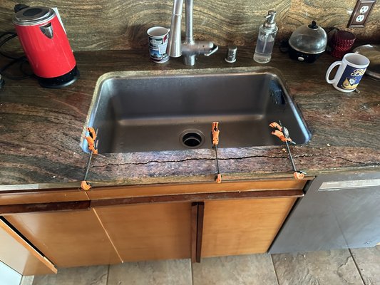 Rod Crack Repair in Del Mar - This Job was in extremely bad shape prior to the start of work. The countertop had been previously repaired by someone, who added glue to the existing crack and thought it would hold. Unfortunately the cause of the issue still remained and as you can see the countertop crack had grown very wide and started to crumble the counter. We pulled the crack apart and removed the steel which caused the issue and then meticulously were able to put it back together using all of the original pieces. Our customer was ecstatic to have a permanent repair and not being able to tell there was ever an issue to begin with. Rod Crack Repair in Del Mar - This Job was in extremely bad shape prior to the start of work. The countertop had been previously repaired by someone, who added glue to the existing crack and thought it would hold. Unfortunately the cause of the issue still remained and as you can see the countertop crack had grown very wide and started to crumble the counter. We pulled the crack apart and removed the steel which caused the issue and then meticulously were able to put it back together using all of the original pieces. Our customer was ecstatic to have a permanent repair and not being able to tell there was ever an issue to begin with.