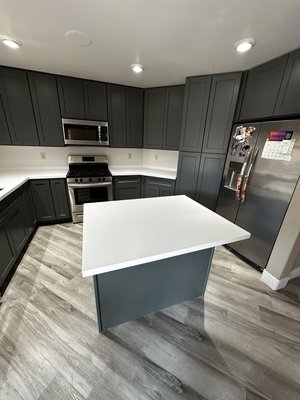 Grey Shaker Cabinets with Corian Glacier White Countertops. - Remodel of an old kitchen with gorgeous Grey Shaker Cabinets with Corian Glacier White Countertops.