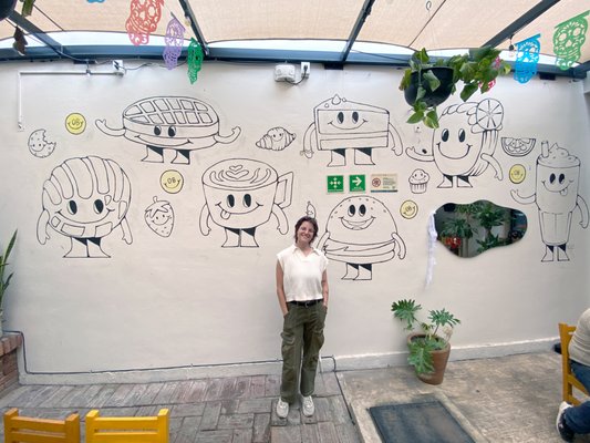 Cafe/Restaurant Food Character Mural - This playful doodle character wall was created for Oscuro Brebaje, a vibrant restaurant in Oaxaca, Mexico. I transformed their menu items into whimsical, one-of-a-kind characters, bringing everything from waffles and iced drinks to burgers to life on the wall. Each design is a fun, imaginative interpretation of their offerings, adding a unique and lively touch to the space. Cafe/Restaurant Food Character Mural - This playful doodle character wall was created for Oscuro Brebaje, a vibrant restaurant in Oaxaca, Mexico. I transformed their menu items into whimsical, one-of-a-kind characters, bringing everything from waffles and iced drinks to burgers to life on the wall. Each design is a fun, imaginative interpretation of their offerings, adding a unique and lively touch to the space.