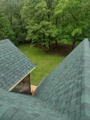 Ashphalt Shingle Roof - This roof shows a typical asphalt shingle roof that was completed using green tinted shingles to match the style of the log cabin being covered. Ashphalt Shingle Roof - This roof shows a typical asphalt shingle roof that was completed using green tinted shingles to match the style of the log cabin being covered.