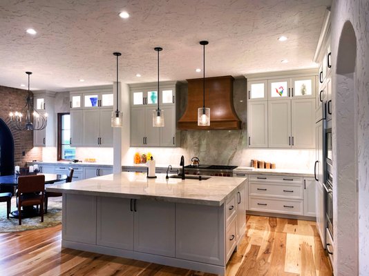 Modern Kitchen and Bar Remodel - This remodel was done on an outdated kitchen and wet bar that needed to be brought back to life. It's set into a Mediterranean style home so we wanted to keep that warm feel of the architecture while modernizing the kitchen through the finishes, fixtures and open layout. The custom wood hood over the gas range adds another nice tough of warmth to the space. It's the perfect kitchen to entertain guests or just get a little crazy with a creative recipe. This is definitely one of our favorite projects we've gotten to work on! Modern Kitchen and Bar Remodel - This remodel was done on an outdated kitchen and wet bar that needed to be brought back to life. It's set into a Mediterranean style home so we wanted to keep that warm feel of the architecture while modernizing the kitchen through the finishes, fixtures and open layout. The custom wood hood over the gas range adds another nice tough of warmth to the space. It's the perfect kitchen to entertain guests or just get a little crazy with a creative recipe. This is definitely one of our favorite projects we've gotten to work on!