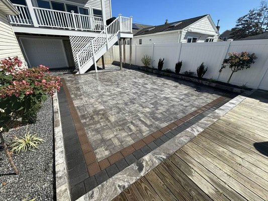 Backyard Paver Patio Installation & Drainage - This backyard was in bad shape due to poor gradiing & leveling upon home raise. We took the existing grade, Fixed it. We installed spider drains & a drainage solution to divert the water away from the home. We then established a permanent grade & installed a RCA/Concrete base with cambridge pavers. We did a double border & finished with g2 Alliance poly metric sand. In the garden beds, we did sprinkler installation & had our partners at Long Island Garden Kings come up with simple yet beautiful design. This is one beautiful backyard now! Backyard Paver Patio Installation & Drainage - This backyard was in bad shape due to poor gradiing & leveling upon home raise. We took the existing grade, Fixed it. We installed spider drains & a drainage solution to divert the water away from the home. We then established a permanent grade & installed a RCA/Concrete base with cambridge pavers. We did a double border & finished with g2 Alliance poly metric sand. In the garden beds, we did sprinkler installation & had our partners at Long Island Garden Kings come up with simple yet beautiful design. This is one beautiful backyard now!