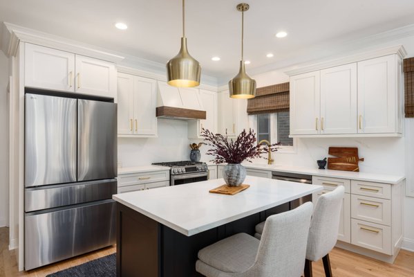 Leland Kitchen Remodel: Bright Transitional Elegance - This kitchen renovation masterfully pairs white Shaker cabinetry with a dark island for a timeless, high-contrast look. Brass pulls and pendant lights provide a sophisticated glow, perfectly complementing the Calacatta Bologna quartz countertops. The design prioritizes bespoke utility, featuring professional-grade appliances and a dedicated bar unit with matte black mullion glass doors and open wood floating shelves. It is a refined, functional space that serves as the modern heart of the home.
Project designed by Chi Renovation, a renowned renovation firm based in Skokie. We specialize in general contracting, kitchen and bath remodeling, and design & build services. We cater to the entire Chicago area and its surrounding suburbs, with emphasis on the North Side and North Shore regions. You'll find our work from the Loop through Lincoln Park, Skokie, Evanston, Wilmette, and all the way up to Lake Forest.
For more info about Chi Renovation, click here: https://www.chirenovation.com/ Leland Kitchen Remodel: Bright Transitional Elegance - This kitchen renovation masterfully pairs white Shaker cabinetry with a dark island for a timeless, high-contrast look. Brass pulls and pendant lights provide a sophisticated glow, perfectly complementing the Calacatta Bologna quartz countertops. The design prioritizes bespoke utility, featuring professional-grade appliances and a dedicated bar unit with matte black mullion glass doors and open wood floating shelves. It is a refined, functional space that serves as the modern heart of the home.
Project designed by Chi Renovation, a renowned renovation firm based in Skokie. We specialize in general contracting, kitchen and bath remodeling, and design & build services. We cater to the entire Chicago area and its surrounding suburbs, with emphasis on the North Side and North Shore regions. You'll find our work from the Loop through Lincoln Park, Skokie, Evanston, Wilmette, and all the way up to Lake Forest.
For more info about Chi Renovation, click here: https://www.chirenovation.com/