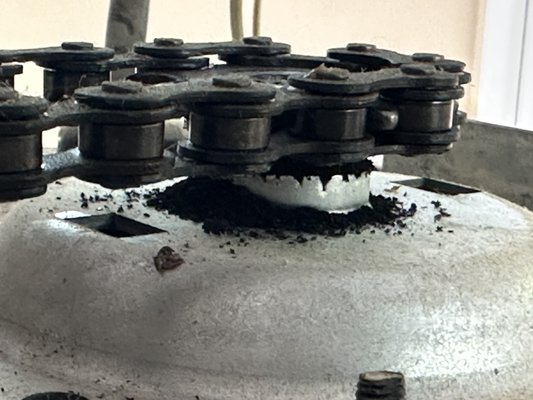 Opener replacement - The customer called because they kept hearing the chain slapping against the rail every time the opener would open and close.  Upon inspection it was noticed that the gear and sprocket had a big pile of metal shavings at the foot of the shaft. I presented the customer with the option of repairing the opener or replacing it. The existing opener was from 2006, the home owner opted to replace the opener with a new one