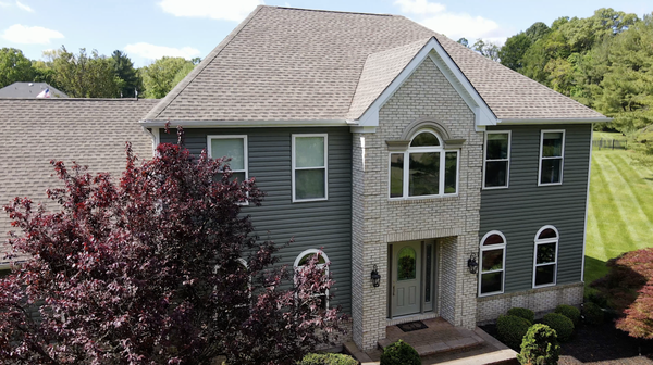 Siding, Windows, and Doors - This exterior upgrade included a new front door, 33 custom-made windows, a slider patio door, seamless gutters, and a full siding replacement using Alside Dutchlap in the color Mountain Fern. A beautiful refresh with lasting curb appeal.