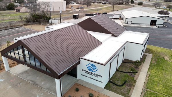24-Guage Mansard Brown Snap-Lock with Mulehide TPO, Boys & Girls Club Nolanville, TX - Removed existing roof and installed new 24-Gauge Mansard Brown Snap-Lock roof system, as well as a mechanically fastened Mulehide TPO flat roof, with custom mansard brown coping cap, through the wall scuppers, 24-GA color matched collector heads and box gutters on the front elevation.