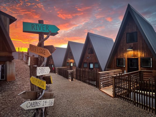 A-FRAME CABINS - We fell in love with the shape of these triangular A-frame cabins because, to us, they look like a mountain range or river waves when they are all lined up together. Whatever they inspire for you, we hope to share a little bit of the river-life with you right here in Asheville, NC. All cabins are stand-alone units with a private bathroom, queen bed, queen sleeper-sofa, seated workspace, mini-fridge, microwave, electric kettle with coffee/tea, HVAC, private balcony/deck with hammock, books, games, record player, and high-speed WiFi. Some of our cabins are even dog-friendly and/or wheelchair-friendly.