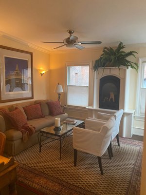 Firehouse Suite - “Firehouse Suite”
(Mon-Thurs $185, Fri-Sun $200 (2 night min) Applicable Sales Tax & 10% Service Charge per room.
Weekend rates apply for all major holidays. Check for Specials on home page.

(One Night if available on request with $25 Charge, plus applicable tax & 10% Service Charge.) Please call directly 347-744-9322 or submit the "One Night Request Form online, under BOOK NOW!

Located on the second floor, it has a separate entrance off the side porch and is a self-contained. In winter the porch gets enclosed and houses all our plants and becomes a temporary greenhouse.  Great place to leave your boots when it snows.

It is partially cantilevered over the water at the back, so you have a view of the tidal creek. It consists of a queen bed, dressing room/bathroom with shower, living room with gas fireplace and an eat-in kitchen. The full size couch can accommodate a child or adult if necessary. One parking space per room provided.

Your choice of a "Help Yourself" Organic Breakfast or if you prefer "No Breakfast - Coffee or Tea Only", there is a reduction of $15 on the regular daily rate.

NOYE: If you are staying 3 days or less, we do offer a prepared breakfast.  Just let us know your preference!

*All cleaning products and breakfast supplies are organic.

A little history: During its life as a Horse drawn Firehouse, the Firemen would have used this area as sleeping quarters, and the living room was used as a kitchen. The fire pole was where the shower currently is.

Amenities include:
• Fine Linens & Bedding
• Romantic Lighting
• Fine Linens & Bedding
• Romantic Lighting
• Air Conditioning in the bedroom & living room
• High Definition Flat Screen TV in bedroom
• Furnished with Twin Size Couch & Desk
• Private Entrance and Porch
• Gas Fireplace
• Private Eat in Kitchen
• Organic Breakfast Provided
• Daily Maid Service (By Request Only)
• Ceiling Fans
• Bathrobes
• Shampoo, Conditioner, Lotion
• Hair Dryer
• Wireless Internet Access
• Netflix & Prime Available