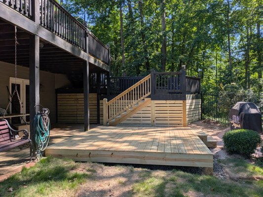 Deck Work - Customer had an not so good looking backyard, with a visible access point into the septic tank. We were able to cover that up while also providing a nice platform to exist on. We laid down plastic and gravel underneath to help move water away from underneath the structure. New stairs are much safer, with a lower step rise to make things easier. The 1x under encloser also matches the style on the front of the home! Deck Work - Customer had an not so good looking backyard, with a visible access point into the septic tank. We were able to cover that up while also providing a nice platform to exist on. We laid down plastic and gravel underneath to help move water away from underneath the structure. New stairs are much safer, with a lower step rise to make things easier. The 1x under encloser also matches the style on the front of the home!