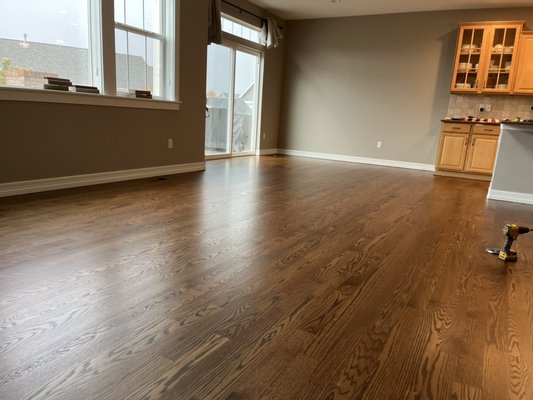 Red oak with provincial stain and satin finish - We added hardwood to family room, office and dining room and refinished existing hardwood floors with provincial stain and satin finish.