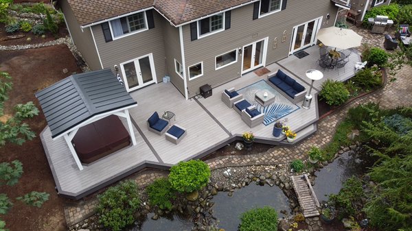 Black Diamond Deck + Pergola - This huge composite deck features AZEK Vintage in Coastline & Dark Hickory with a gorgeous pergola & metal roof.