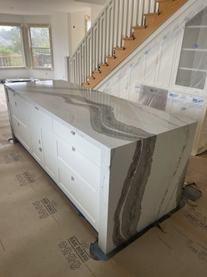 Kitchen Island with Waterfall Legs - This kitchen remodel featured an island with 2 waterfall legs. The homeowners selected Cambria 2cm Skara Brae Quartz for the material. This quartz material has a very distinct dark veins running through the middle of the layout. The design team did a great job carrying the vein across the top and over both waterfalls for a continuous look. Kitchen Island with Waterfall Legs - This kitchen remodel featured an island with 2 waterfall legs. The homeowners selected Cambria 2cm Skara Brae Quartz for the material. This quartz material has a very distinct dark veins running through the middle of the layout. The design team did a great job carrying the vein across the top and over both waterfalls for a continuous look.