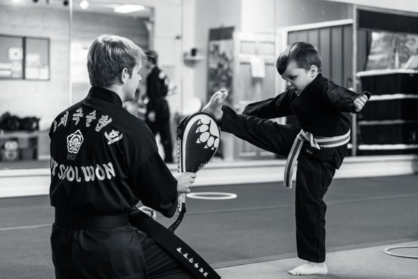 Little Warriors in the Making! - We have traditional martial arts classes for kids from age 4-12. This program is a fun self-defense classes that focus on leadership, confidence and martial arts skills.
This program is broken into 3 age groups:
Tiny Tigers is for students age 4 to 5.
Lil'Dragons is age appropriate for most 6-8 year olds
Junior classes are for students from 8 to 12 years old and are broken up into beginner and advanced classes.
*flexibility in age requirements - ask us about doing a free assessment to help discover which program is right for your child (and your families schedule). Little Warriors in the Making! - We have traditional martial arts classes for kids from age 4-12. This program is a fun self-defense classes that focus on leadership, confidence and martial arts skills.
This program is broken into 3 age groups:
Tiny Tigers is for students age 4 to 5.
Lil'Dragons is age appropriate for most 6-8 year olds
Junior classes are for students from 8 to 12 years old and are broken up into beginner and advanced classes.
*flexibility in age requirements - ask us about doing a free assessment to help discover which program is right for your child (and your families schedule).