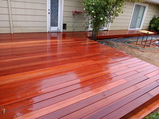 Backyard Transformation - What a fun transformation! It's nice seeing the transformation in this yard and the client is super happy. We added Indonesian hardwood decking called Batu, concrete square stepping stones with decorative gravel, and a natural stone wall.