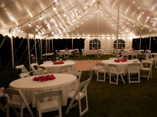 Campton Hills Wedding - This 30x70 tent for a Campton Hills wedding fit perfectly in our customers backyard. Features included swooped lighting, dance floor, linens, table decorations and flatware. The reception started under a big oak tree with chairs being moved under the tent following the ceremony finale. It was a beautiful set-up and we were lucky enough to get get to know the bride and groom during the entire process. Congrats on tying the knot!