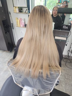 18" handtied weft sew-in hair extensions - My model client already had long hair but she wanted it to feel more thick. She also wanted to be more blonde. I was able to achieve these results by applying 18" handtied weft sew-in extensions that we ordered in ash blonde. No chemical service was required!