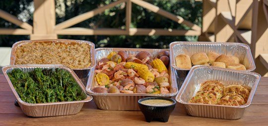 Family Seafood Meal - Our picks from our Seafood Menu! Serving 10, this package includes:

Low Country Shrimp Boil: Local Gulf Shrimp, Andouille Sausage, red potatoes, and corn on the cob with our signature spice blend.
Hooked's Famous Crab Cakes: Panko encrusted crab cakes made from fresh crab, shaved celery, diced red pepper, and lemon aioli. Served with a lemon aioli whole grain mustard.
Herb Panko Crusted Mac and Cheese: Creamy Monterey Jack cheese bechamel sauce, folded with ziti pasta and baked golden brown.
Grilled Broccolini: Fresh broccolini tossed in roasted garlic oil and sea salt and lightly grilled.
Served with a baguette and garlic butter.

48 hours notice required.
$650.00 per 10 servings