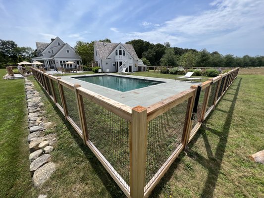 Framed wired fence - Framed 2x4 black welded wire with red cedar posts and rails.