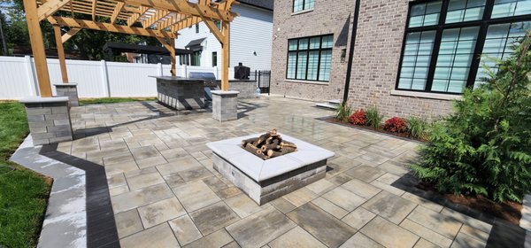 Outdoor living - Custom backyard outdoor living space featuring a paver patio, wood pergola, outdoor kitchen, and fire pit—designed and built for comfortable entertaining and long-lasting beauty. Outdoor living - Custom backyard outdoor living space featuring a paver patio, wood pergola, outdoor kitchen, and fire pit—designed and built for comfortable entertaining and long-lasting beauty.