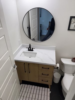 Costa Mesa bathrooms and flooring throughout - This was full  remodel for two bathrooms ,new floor tile in the master bathroom, new island slab in the kitchen, new slab on the upstairs cabinets and all new luxury vinyl plank the downstairs on the stairs and the second floor landing.